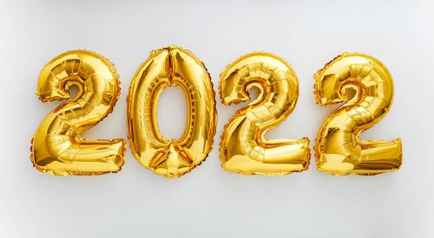 2022 balloon text on white background. Happy New year eve invitation with Christmas gold foil balloons 2022. Flat lay long web banner - Photo, image