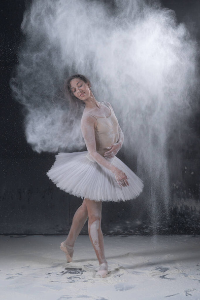 young beautiful ballerina dancing in white flour - Photo, Image