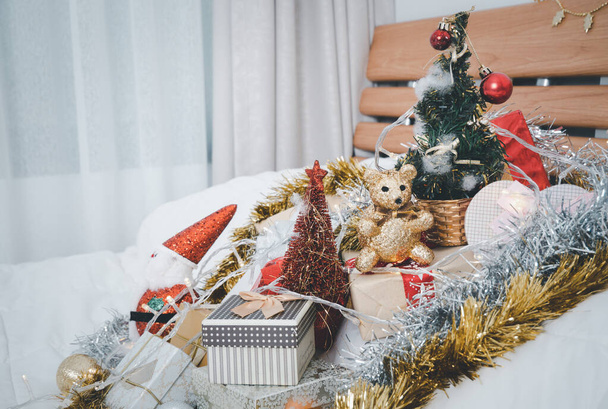 Christmas gift boxes ,pine tree ,santa claus, ball and ribbon ornaments  with lighting on white floor,Christmas background - Valokuva, kuva