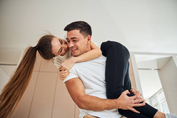 Loving couple hugging and having fun at home - Valokuva, kuva