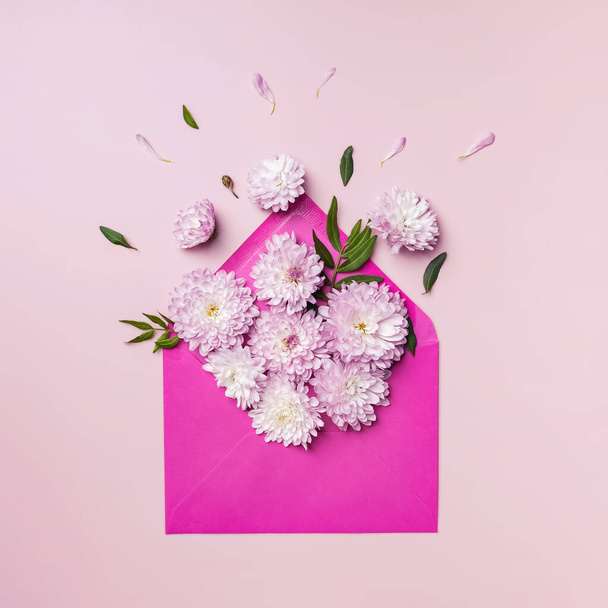 Pink envelope full of various flowers. - Φωτογραφία, εικόνα