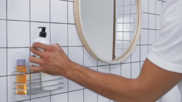 man in white t-shirt applying liquid soap and washing hands - Filmmaterial, Video