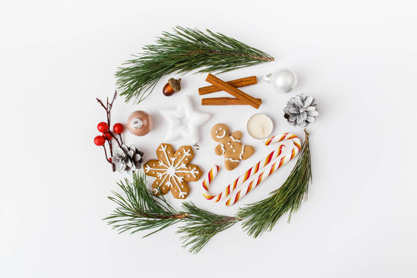 Trendy creative Christmas, winter, new year composition. Pine tree branches, Christmas decorations on white background. Flat lay, top view - Fotó, kép