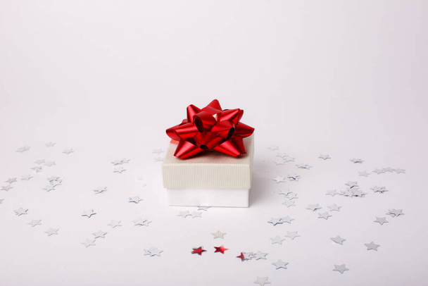 gift box with confetti stars on white background - Photo, Image