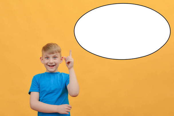 Boy holds thumbs up, place for text, advertising, lettering on a yellow background. - Foto, Imagem
