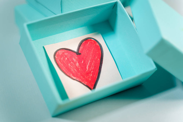 Heart drawn inside a turquoise gift box - Photo, Image
