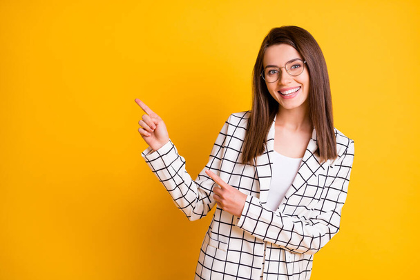 Photo of adorable cute journalist wear plaid blazer pointing two fingers empty space isolated yellow color background - Foto, imagen