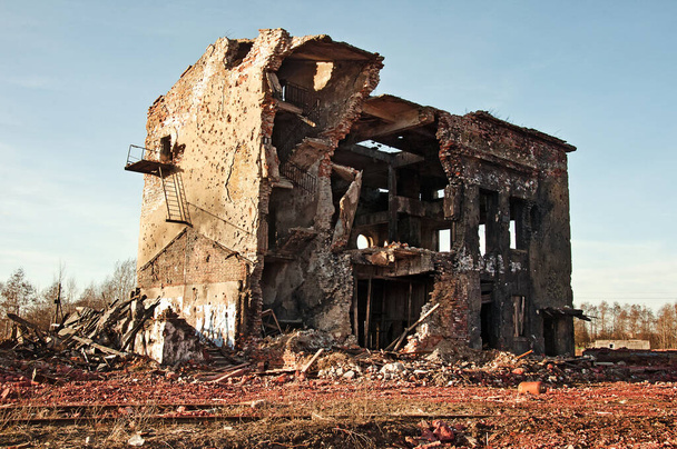 Landscape of ruined buildings at sunset, image of decrepitude or natural disaster - Photo, Image