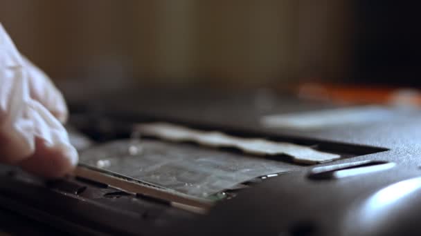 Close-up of a technician adding RAM to notebook - Footage, Video