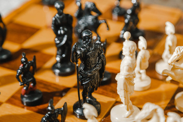 White and black chess pieces stand on board during a chess game - Foto, immagini