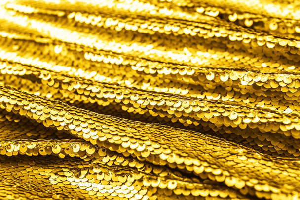 Golden shiny fabric with sequins, abstract background. Color 2021. - Foto, Imagem