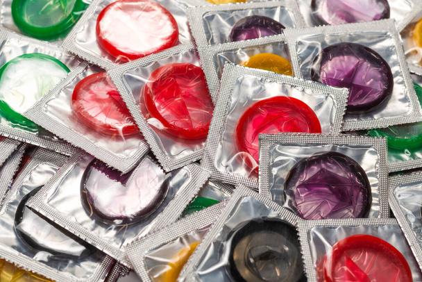 Colorful condoms background. Top view.  - Foto, afbeelding