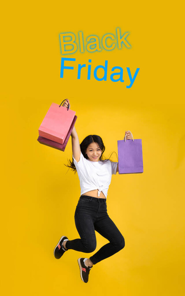 Beautiful woman inviting for shopping in black friday, sales concept. Vertical flyer, yellow background - 写真・画像