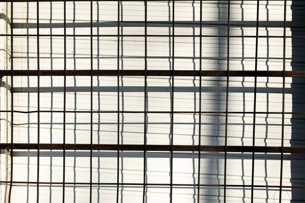 A closeup shot of steel matting on a building under sunlight - Valokuva, kuva