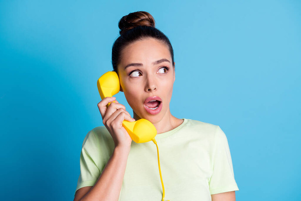 Close-up portrait of her she nice attractive charming gorgeous cute lovely pretty brown-haired girl talking on yellow retro phone isolated bright vivid shine vibrant blue color background - Photo, image