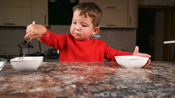 Portrait of a child in the kitchen. High quality photo - Φωτογραφία, εικόνα