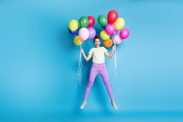 Full length body size photo of amazed girl jumping high with balloons staring with opened mouth isolated on bright blue color background - Φωτογραφία, εικόνα