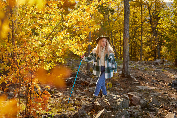 happy caucasian blonde woman is enjoying time in the forest - 写真・画像