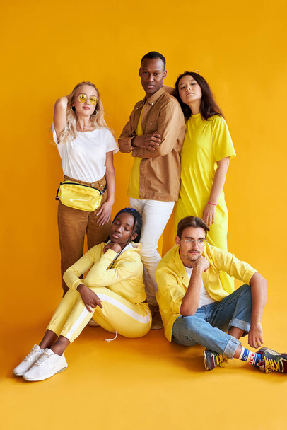 group of multiethnic friends, people of different cultures isolated on yellow background - Foto, Bild