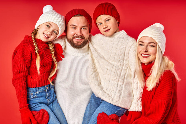 portrait of positive smiling family with children isolated on red wall - 写真・画像