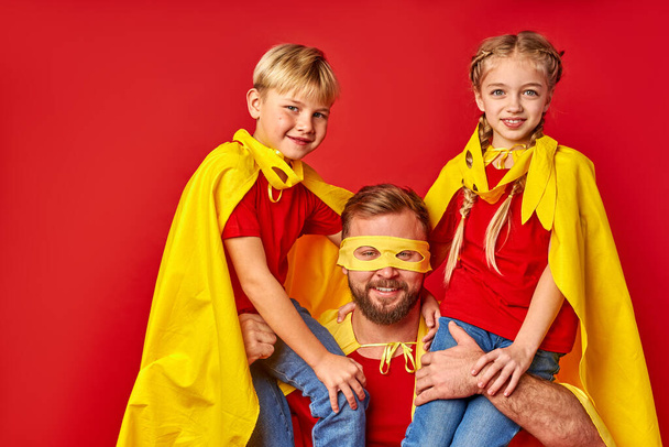 caucasian man and kids in superhero cloaks - Fotoğraf, Görsel