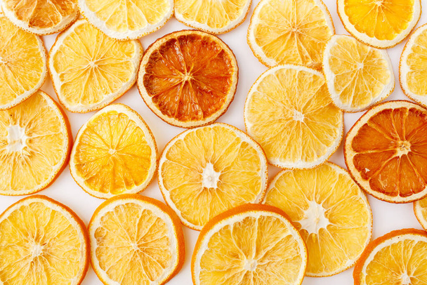 Christmas, winter, new year composition. Slices of dry oranges. Natural Citrus fruits pattern. Food background. Flat lay, top view - Фото, изображение
