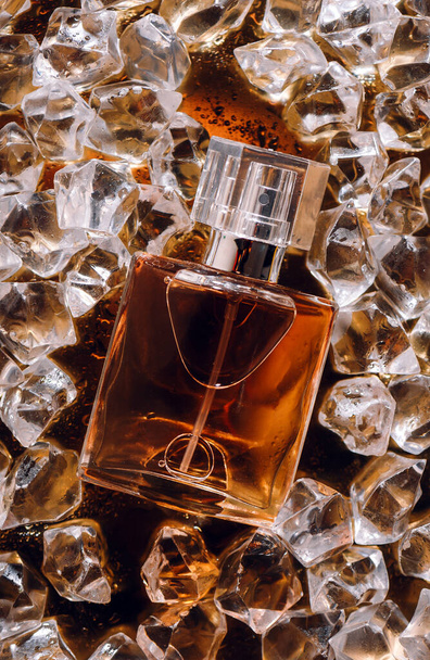 bottle of parfum on ice, cosmetic fresh water movement perfume, spark, cosmetic, aroma, fashion, fresh, drops, refresh your soul with perfumes, aroma brings happiness, mood and good luck, perfume sets. - Photo, Image
