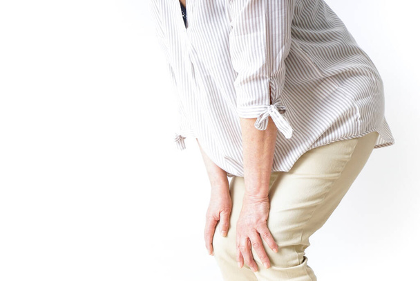 Aged woman suffering from pain in knee - Foto, Bild