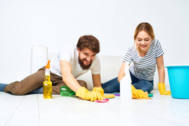 Jeune couple détergent laver le sol travailler ensemble style de vie - Photo, image