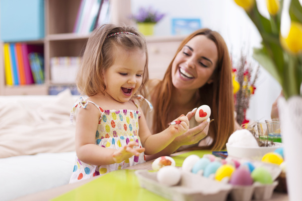 Mother and her baby painting easter eggs - Foto, Imagen