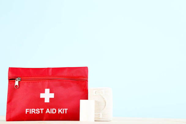 First aid kit with medical bandages on mint background - Fotografie, Obrázek
