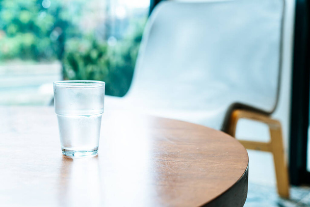 glass of water on wood table - 写真・画像