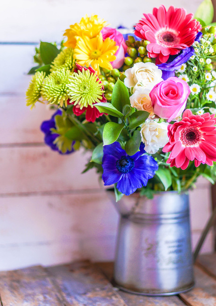 Colorful bouquet of spring flowers in vintage vase on rustic wooden background - Фото, зображення