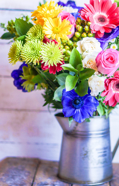 Colorful bouquet of spring flowers in vintage vase on rustic wooden background - Foto, Imagem