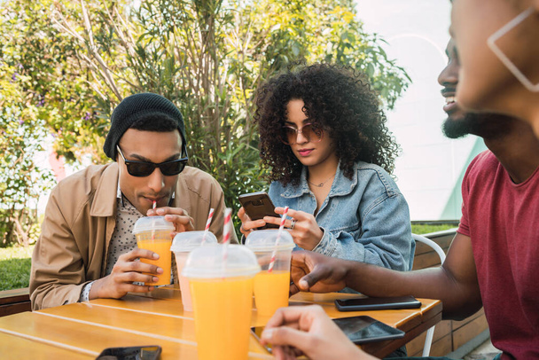 Afro friends having fun together while drinking fruit juice. - Fotó, kép