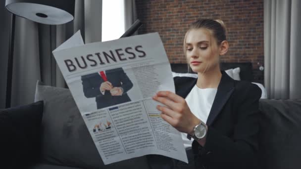 деловая женщина в формальной одежде читает деловую газету  - Кадры, видео