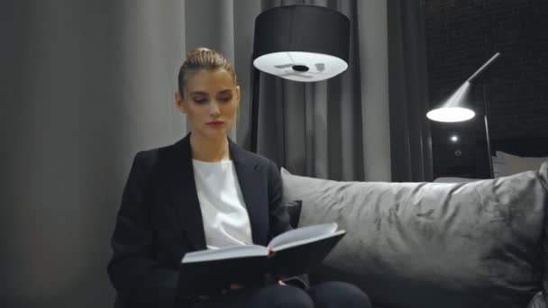 businesswoman in formal wear flipping through pages of notebook - Footage, Video