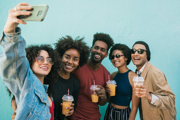 Multi-ethnic group of friends taking a selfie. - Foto, afbeelding