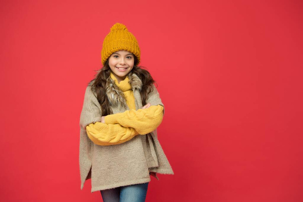 cheerful child wear warm winter clothes. seasonal kid fashion. stay cozy and comfortable. happy childhood. cold season look for teen girl. knitted clothing style. take care of health - Фото, зображення