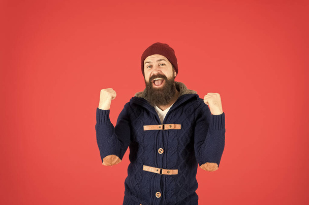 Success. Emotional expression. Casual clothes for winter season. Hipster with long beard. Hipster lifestyle. Stylish outfit hat accessory. Man bearded hipster stylish fashionable jumper and hat - Foto, imagen