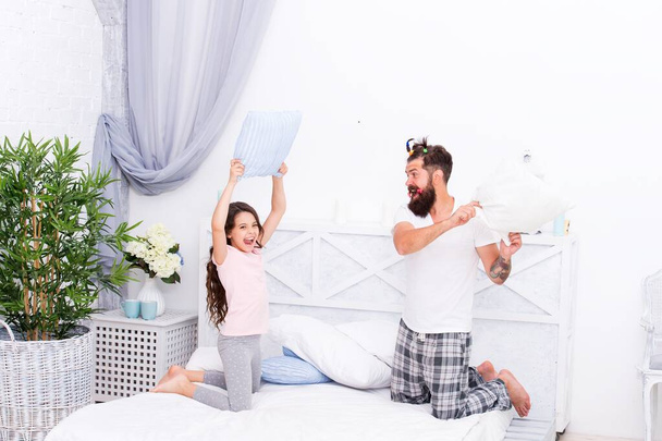Real feelings. playing together in free time. funny hair styling. entertainment. father and daughter having fun. kid and dad fighting with pillows. happy family day. celebrate fathers day - Photo, image