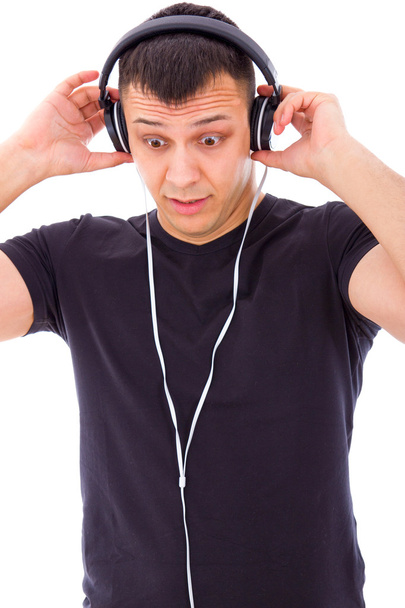 man surprised by something unexpected on headphones - Photo, image