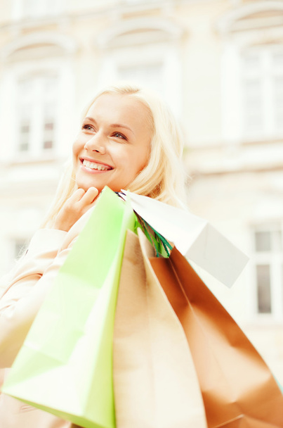 Woman with shopping bags in city - Photo, image