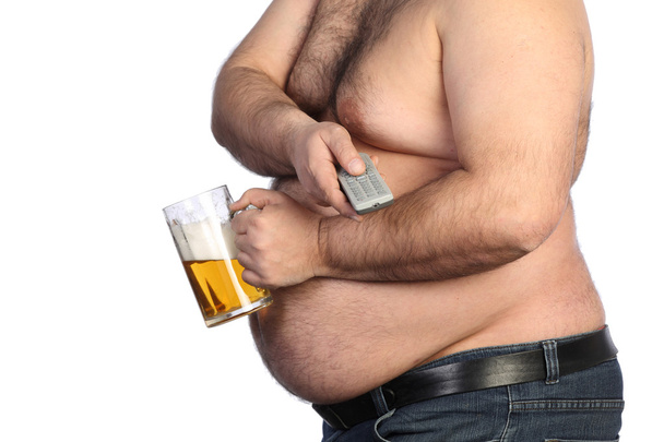 Fat man holding beer, chips and tv remote - 写真・画像