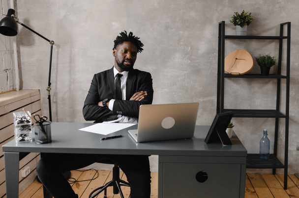 Confident young african man look at webcam conference video calling in office, happy mixed race entrepreneur talking doing online video chat job interview sit at desk - Foto, immagini