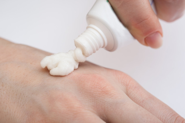 Putting cream on hand - Photo, image