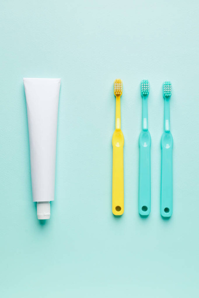 Toothbrushes and paste on color background - Photo, Image