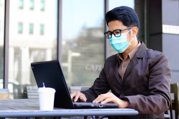 Asian businessmen Wear medical mask for coronavirus covid-19 protection working in office, coronavirus covid-19 outbreak control - Photo, Image
