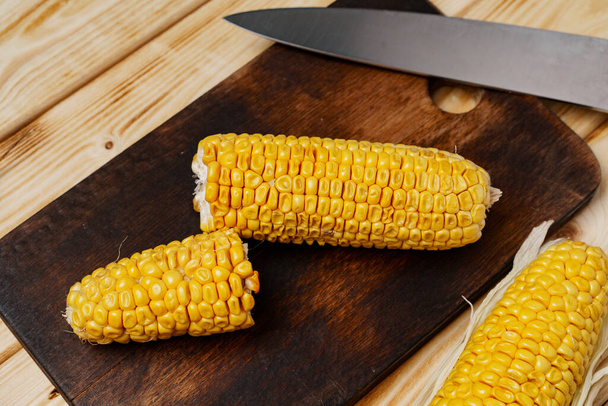 Cobs of corn on wooden cutting board - Zdjęcie, obraz