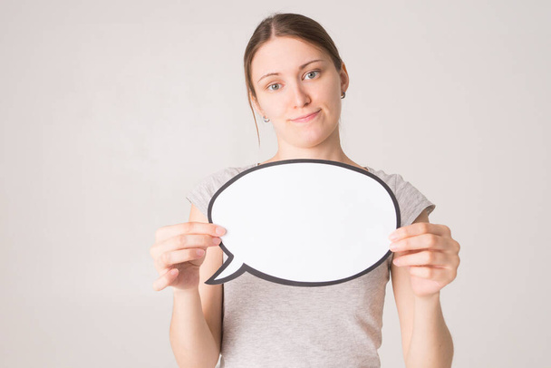 Young woman holding a speech bubble  - Photo, Image